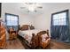 Cozy bedroom with a full bed, bedside table, and an overhead ceiling fan with lights at 825 Parkwood St, Burlington, NC 27215