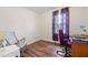 Well-lit room featuring updated floors and a desk and chair perfect for a home office at 825 Parkwood St, Burlington, NC 27215