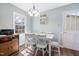 Bright dining room features modern chandelier, matching table and chairs and natural light at 825 Parkwood St, Burlington, NC 27215