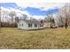Quaint single-story home featuring black shutters and a clean, white exterior on a spacious lot at 825 Parkwood St, Burlington, NC 27215