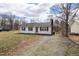 Charming single-story home with a red front door, black shutters, and a well-maintained yard at 825 Parkwood St, Burlington, NC 27215
