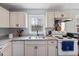 Kitchen features granite countertops, window and matching white cabinets and appliances at 825 Parkwood St, Burlington, NC 27215