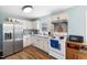 Well-lit kitchen with stainless steel appliances, white cabinetry, and granite countertops at 825 Parkwood St, Burlington, NC 27215