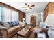 Warm and inviting living room featuring wood paneling, comfortable sofas, and natural light at 825 Parkwood St, Burlington, NC 27215