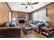 Cozy living room with wood paneling, a brick fireplace, and comfortable seating at 825 Parkwood St, Burlington, NC 27215