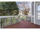 Spacious deck with a view of the grassy backyard and mature trees at 8310 Hempshire Pl # 106, Raleigh, NC 27613