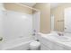 Bright bathroom featuring a bathtub with shower, toilet, and vanity with storage at 8310 Hempshire Pl # 106, Raleigh, NC 27613