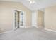 Spacious bedroom featuring a ceiling fan and access to a closet and hallway at 8310 Hempshire Pl # 106, Raleigh, NC 27613