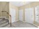 Bright entryway featuring hardwood floors, staircase, and ample closet space at 8310 Hempshire Pl # 106, Raleigh, NC 27613