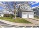 Charming townhouse featuring a two-car garage and beautifully landscaped front yard at 8310 Hempshire Pl # 106, Raleigh, NC 27613