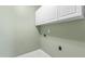 Laundry room with white cabinets and hookups at 8310 Hempshire Pl # 106, Raleigh, NC 27613