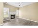 Inviting living room featuring a cozy fireplace, abundant light, and hardwood floors at 8310 Hempshire Pl # 106, Raleigh, NC 27613