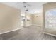 Open-concept living area with hardwood floors, ceiling fan, and abundant natural light at 8310 Hempshire Pl # 106, Raleigh, NC 27613