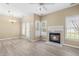 Cozy living room with fireplace, abundant natural light, and hardwood floors at 8310 Hempshire Pl # 106, Raleigh, NC 27613
