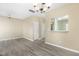 Spacious living area with hardwood floors, open to kitchen, and modern lighting fixtures at 8310 Hempshire Pl # 106, Raleigh, NC 27613