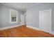 Bedroom with hardwood floors, neutral paint, and windows for natural light at 907 Holloway St, Durham, NC 27701