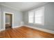 Bedroom with hardwood floors, natural light, and neutral wall paint at 907 Holloway St, Durham, NC 27701