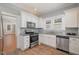 Updated kitchen with white cabinets, stainless steel appliances, and granite countertops at 907 Holloway St, Durham, NC 27701