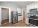 Bright kitchen with stainless steel appliances, modern countertops, and white cabinetry at 907 Holloway St, Durham, NC 27701