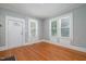 Bright living room features hardwood floors and large windows offering lots of natural light at 907 Holloway St, Durham, NC 27701
