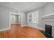 Cozy living room with fireplace and hardwood floors with lots of natural light at 907 Holloway St, Durham, NC 27701