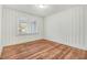 Cozy bedroom with hardwood floors and a window providing natural light at 916 Tyan St St, Rocky Mount, NC 27801