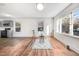 Bright living room featuring hardwood floors, large windows, and a view into the updated kitchen at 916 Tyan St St, Rocky Mount, NC 27801