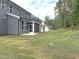 A large, newly sodded backyard with a view of the back of the house and porch at 9160 Dupree Meadow Dr # 13, Angier, NC 27501