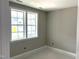 Bright bedroom featuring neutral walls, white trim, and double windows overlooking the yard at 9160 Dupree Meadow Dr # 13, Angier, NC 27501