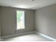 Bedroom with neutral walls and window overlooking the backyard at 9160 Dupree Meadow Dr # 13, Angier, NC 27501