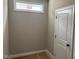 Hallway featuring a window and a white paneled door at 9160 Dupree Meadow Dr # 13, Angier, NC 27501