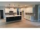 Spacious kitchen boasts a large island, sleek white cabinets, and modern pendant lighting at 9160 Dupree Meadow Dr # 13, Angier, NC 27501