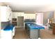 View of the kitchen featuring shaker cabinets, dark hardware, a gray island, and gray backsplash at 9160 Dupree Meadow Dr # 13, Angier, NC 27501