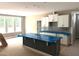 Kitchen featuring white cabinets, gray backsplash and dark island covered with blue protective wrapping at 9160 Dupree Meadow Dr # 13, Angier, NC 27501
