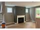 A living room with an olive accent wall and a white fireplace at 9160 Dupree Meadow Dr # 13, Angier, NC 27501