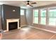 Bright living room featuring a modern fireplace, ceiling fan, and large windows offering natural light at 9160 Dupree Meadow Dr # 13, Angier, NC 27501