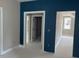 Living room with blue accent wall with white door frames at 9160 Dupree Meadow Dr # 13, Angier, NC 27501