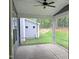 A screened-in porch with a ceiling fan, overlooking the back yard at 9160 Dupree Meadow Dr # 13, Angier, NC 27501