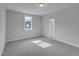 Bedroom with neutral carpet, white walls, window, and door at 9168 Dupree Meadow Dr # 15, Angier, NC 27501
