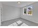 Serene bedroom with neutral walls, carpeted flooring, and a window providing natural light and a peaceful atmosphere at 9168 Dupree Meadow Dr # 15, Angier, NC 27501