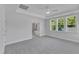 Spacious bedroom featuring tray ceiling, carpet, ceiling fan, and many large windows at 9168 Dupree Meadow Dr # 15, Angier, NC 27501