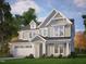 Charming two-story home with gray siding, white trim, and a well-manicured lawn surrounded by mature trees at 9168 Dupree Meadow Dr # 15, Angier, NC 27501