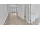 Bright hallway leading to bathroom with wood flooring and white molding at 9168 Dupree Meadow Dr # 15, Angier, NC 27501