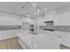 Bright white kitchen featuring a large center island, modern pendant lighting, and stainless steel appliances at 9168 Dupree Meadow Dr # 15, Angier, NC 27501