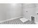 Well-lit laundry room featuring patterned flooring, a utility sink and metal shelving for optimal storage at 9168 Dupree Meadow Dr # 15, Angier, NC 27501