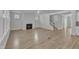 Open floor plan: living room and staircase, featuring a fireplace, and wood flooring at 9168 Dupree Meadow Dr # 15, Angier, NC 27501