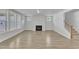 Spacious living room featuring a fireplace, many windows, and wood flooring at 9168 Dupree Meadow Dr # 15, Angier, NC 27501