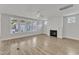 Spacious living room with a fireplace, three panel windows and light wood-look flooring at 9168 Dupree Meadow Dr # 15, Angier, NC 27501