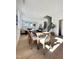 Inviting dining room with a modern table, chairs, and views into living room at 960 Double Helix Rd, Apex, NC 27523