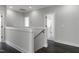 Hallway with hardwood flooring, and a staircase, which enhances flow between spaces at 960 Double Helix Rd, Apex, NC 27523